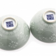 Pair of green glazed bowls with flowers, 20th century