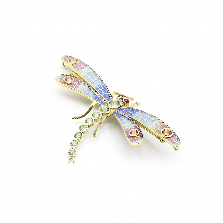 Elegant brooch in the shape of a dragonfly set with precious gems.