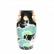Ceramic vase with black background.