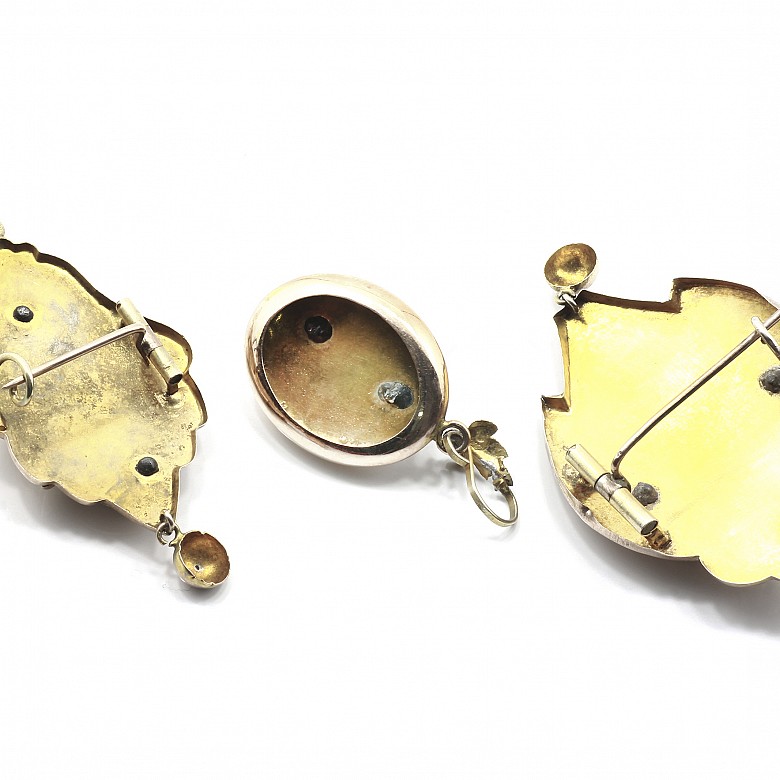 Two brooches and a pendant in a modernist style.