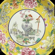 Dish of flowers and treasures with yellow background, 20th century