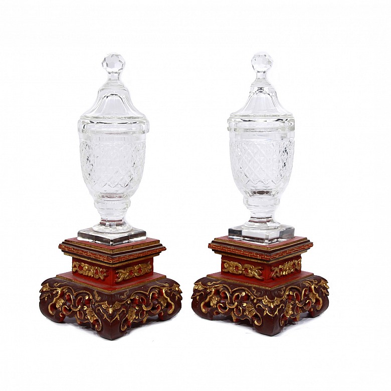 Two glass vases with Chinese wooden bases.