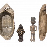 Two figures and two African masks.