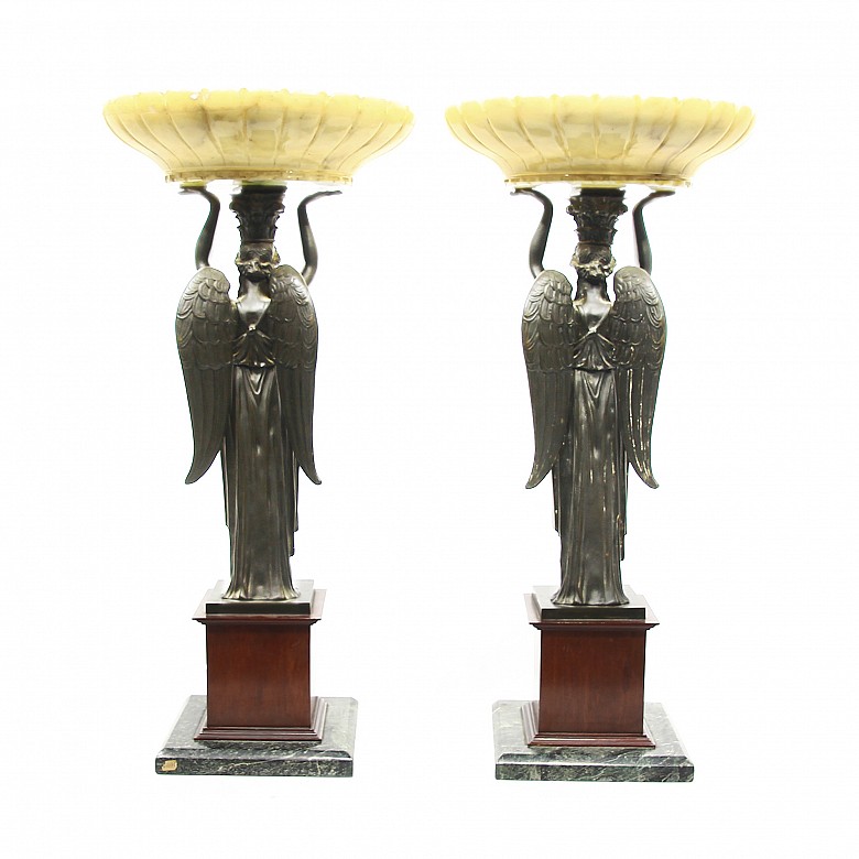 Pair of caryatids holding a marble pile.