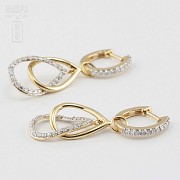 Pair of earrings with movement, in 18k yellow gold and 74 diamonds total weight 0.70cts.