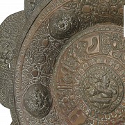 Embossed metal alms dish, Tibet, 19th century