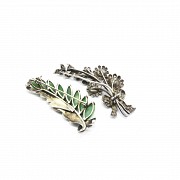 Two silver and jade brooches.