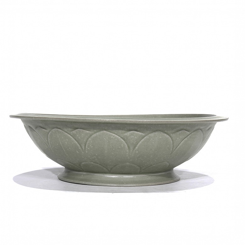 A Yue-style ceramic dish with a celadon glaze.