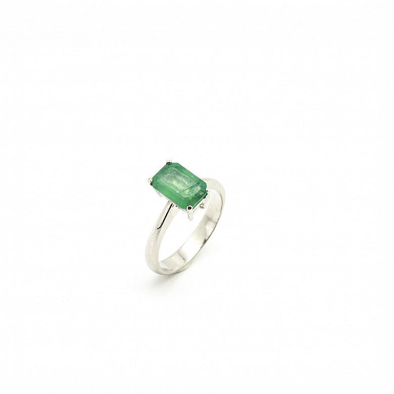 Emerald solitaire in 18k white gold.