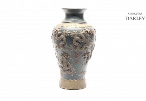 Chinese ceramic vase with relief dragons and blue ground.