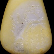 A carved pebble with reliefs, 20th century