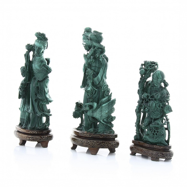 Three malachite sculptures on wooden base, 20th c.
