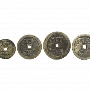 Four Chinese bronze coins.