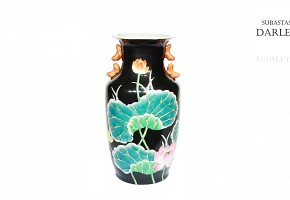 Ceramic vase with black background.