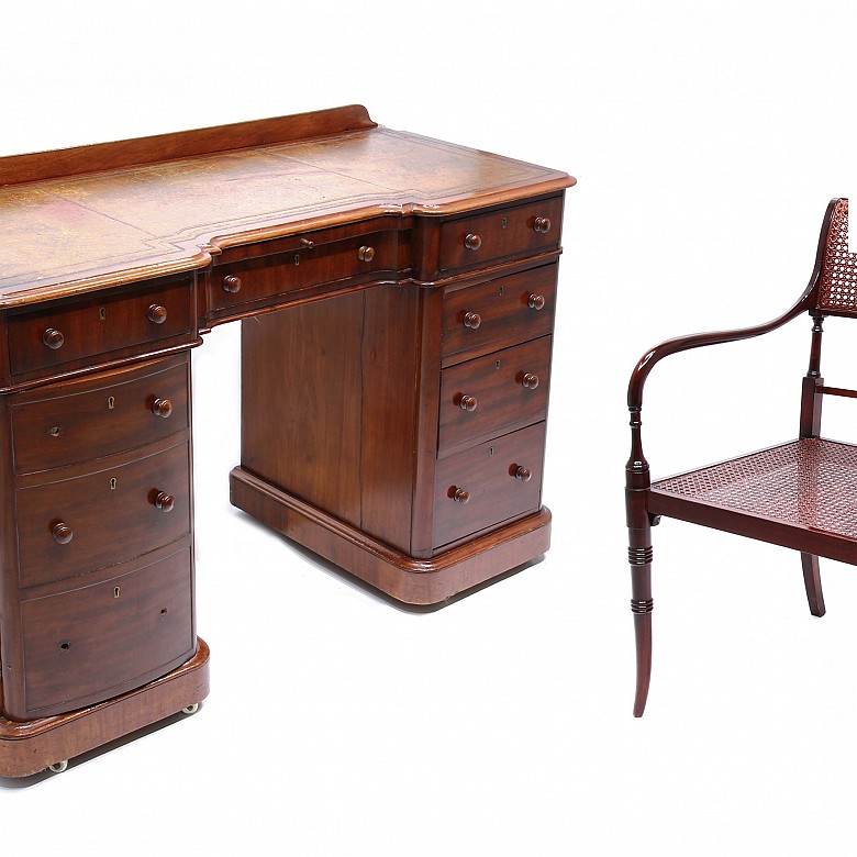 Mahogany English desk and a desk chair .