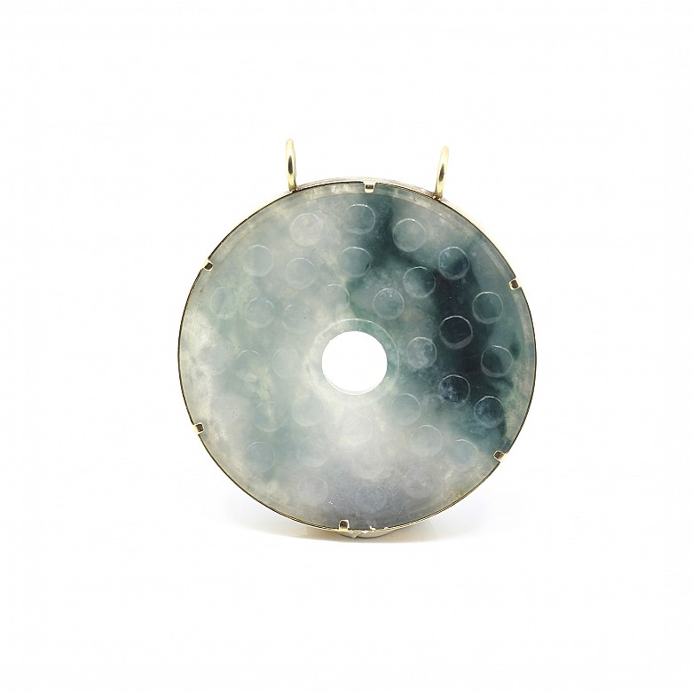 Carved jade medallion with 14k yellow gold setting