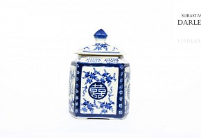 Ceramic container with blue and white lid.