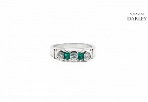 Diamond and emerald ring set in 18k white gold.