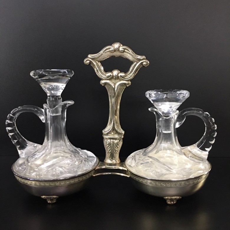 Carved glass cruet and oil pan with silver support.