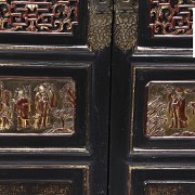 Chinese cupboard with carved and gilded wood panels. early 20th century.