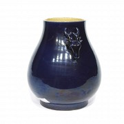 Vase decorated with a deer-shaped handle.