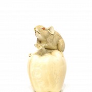 Rat and apple carved in mammoth bone.