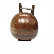 Double mouth jug decorated with images of deities