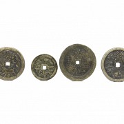 Four Chinese bronze coins.