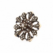 Antique metal brooch with diamonds.