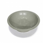 A Yue-style ceramic dish with a celadon glaze.