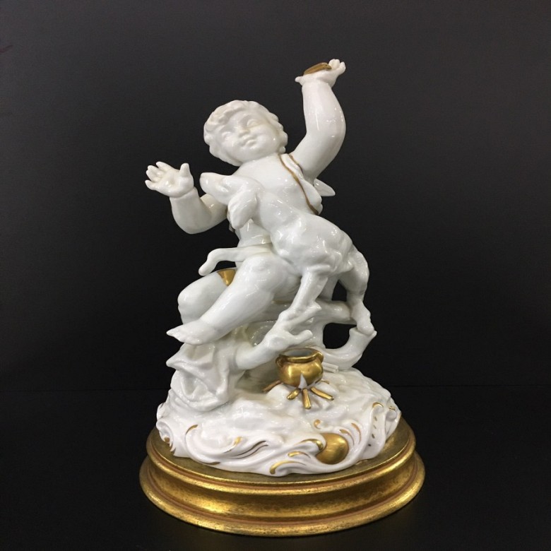 White ceramic angel figure, painted with gold leaf.