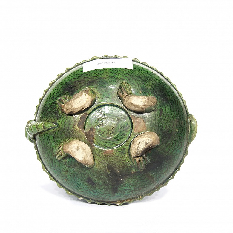 Green vessel in the shape of a turtle.