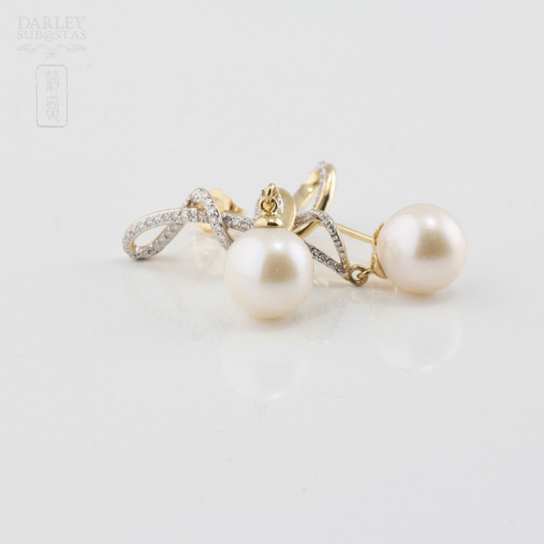 Long earrings with pearls in 18k yellow gold and diamonds.