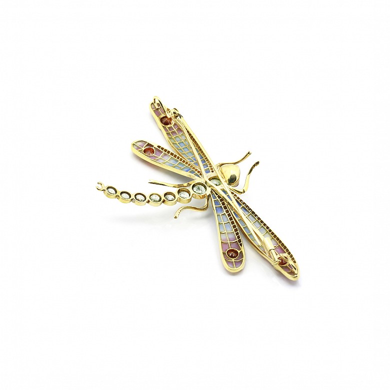 Elegant brooch in the shape of a dragonfly set with precious gems.