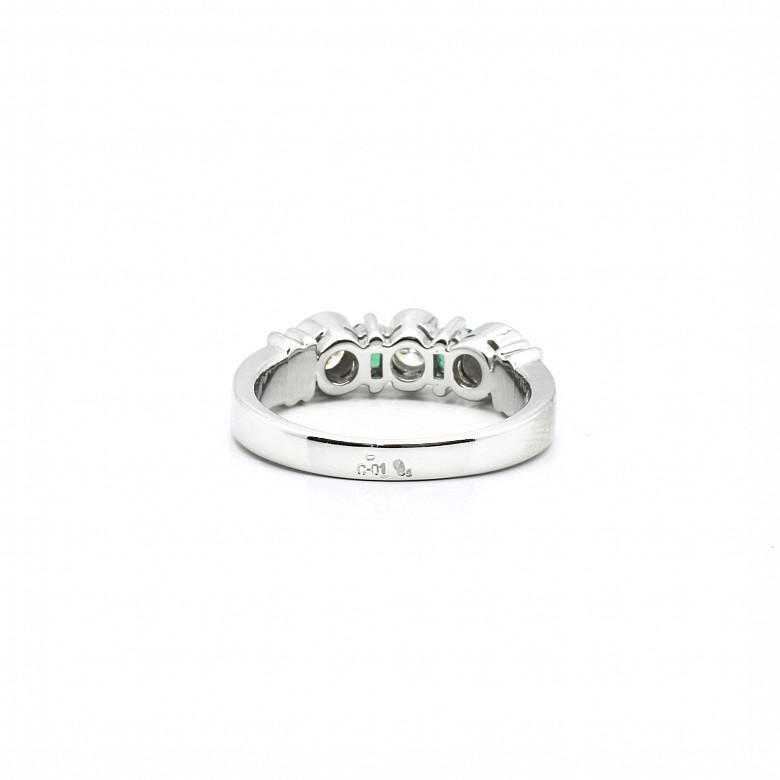 Diamond and emerald ring set in 18k white gold.