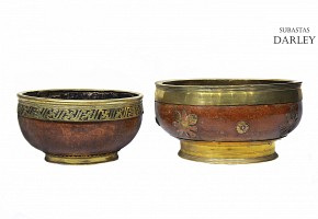 Two large wooden and brass bowls.