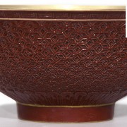 Carved and red-enameled porcelain bowl, Qing dynasty.