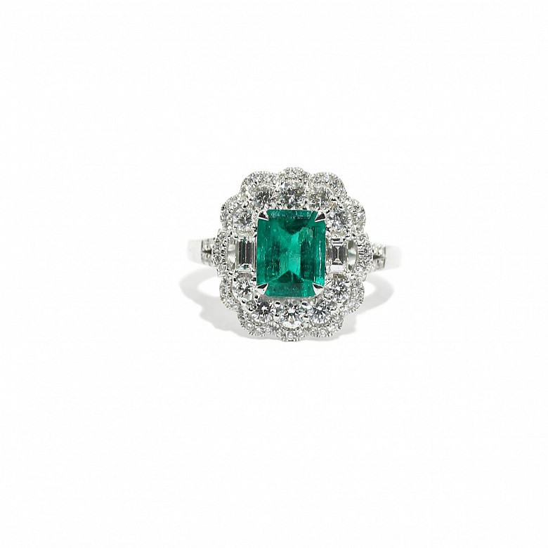 Ring with central Colombian emerald and diamonds.