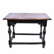 Low ebony table with turned legs.