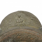 Embossed metal alms dish, Tibet, 19th century