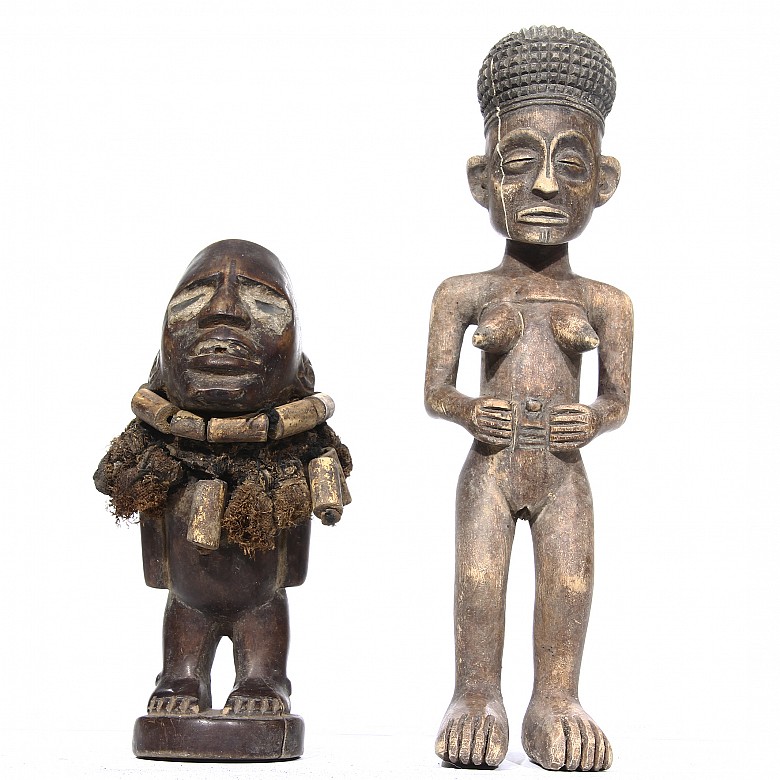 Two figures and two African masks.