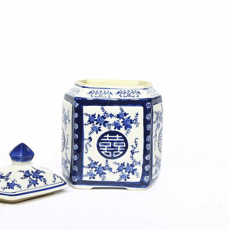 Ceramic container with blue and white lid.