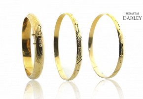 Lot of three bracelets in 18k yellow gold