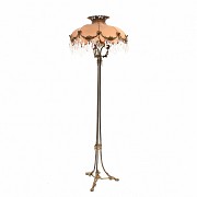 High metal floor lamp and fabric shade and glass medallions.