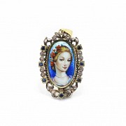 Medal with a portrait in enamel, surrounded by diamonds and sapphires.