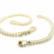 Two cultured pearl necklaces, with 18 k gold clasps