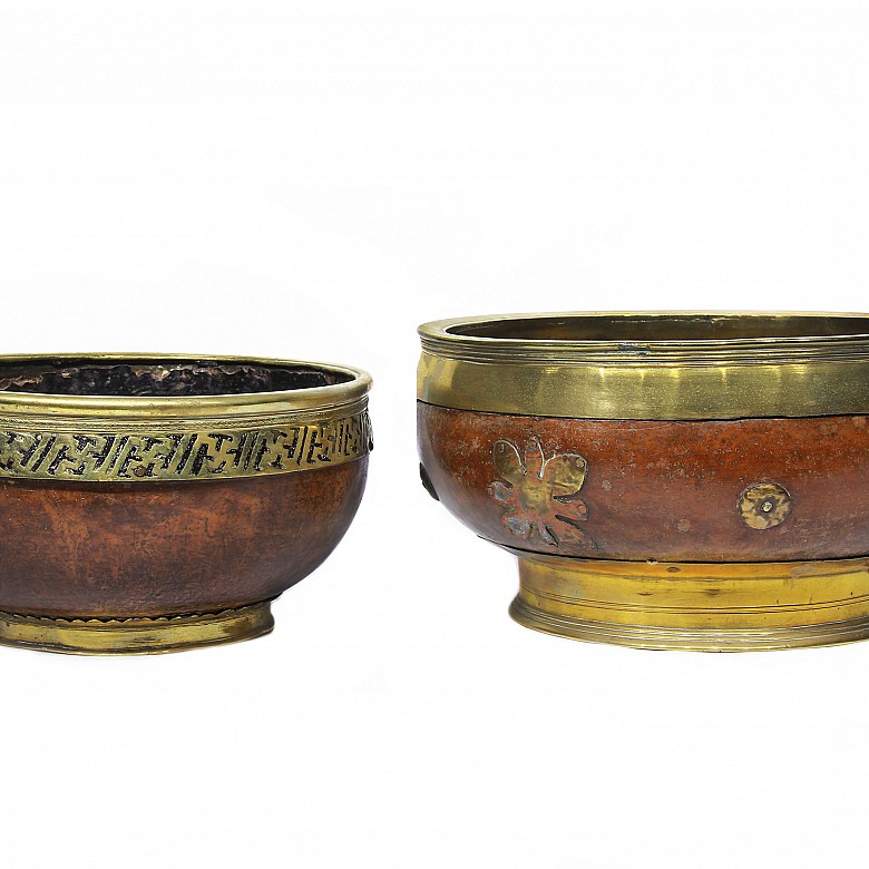 Two large wooden and brass bowls.