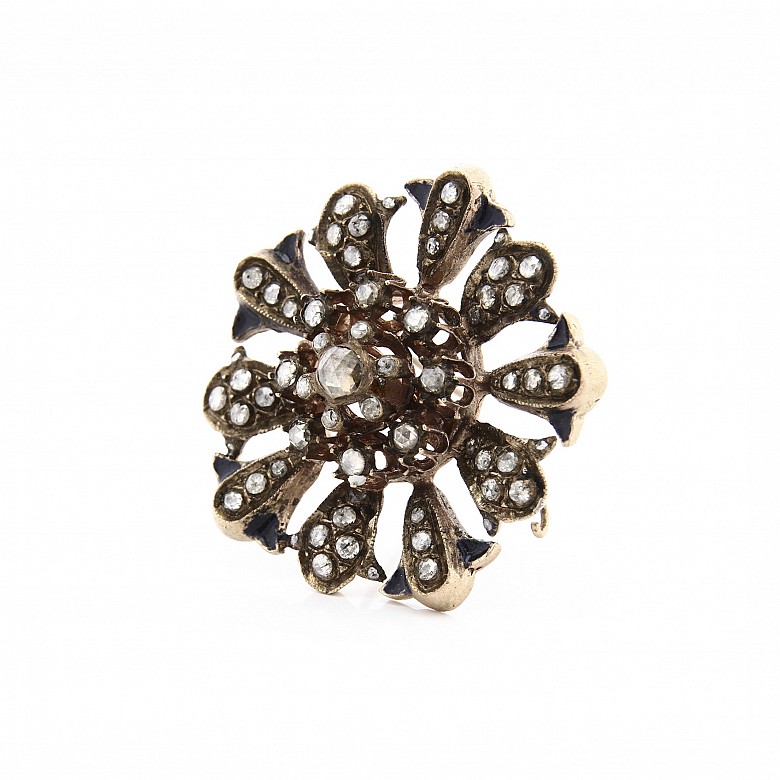 Antique metal brooch with diamonds.