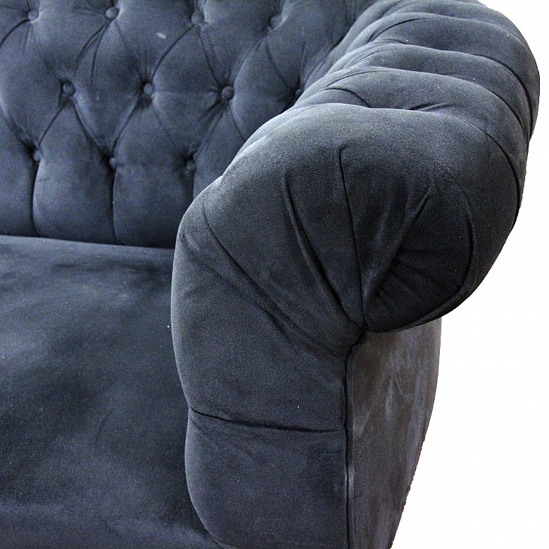 Pair of chester sofas with dark blue upholstery.