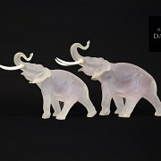 Pair of opaque glass elephants and bone fangs